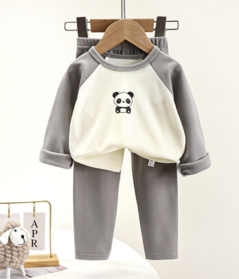Pyjama deux pièces pour bébé composé d’un haut blanc et gris à manches raglan avec motif panda sur le devant, et d’un pantalon gris assorti à taille élastique, en tissu doux et extensible pour un confort optimal durant les nuits fraîches.