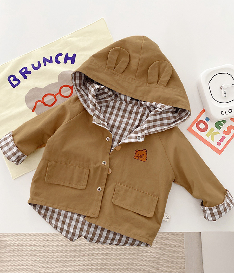 51519-1 Coupe-vent unisexe beige à capuche, léger et résistant. Idéal pour la mi-saison, il offre confort, style et liberté de mouvement au quotidien.