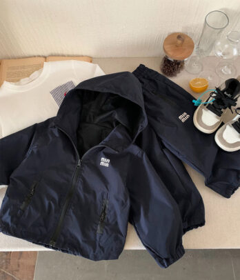 Ensemble sport enfant bleu marine comprenant veste zippée à capuche avec poches et pantalon taille élastique, tissu respirant et confortable pour activités quotidiennes.